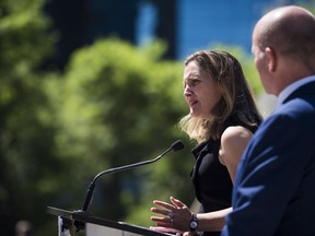 Foreign Affairs Minister Chrystia Freeland speaks at a press conference in Vancouver, B.C. on Monday, August 6, 2018 as MP Randy Boissonnault looks on.