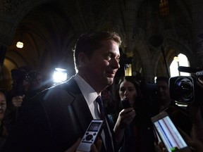 Conservative leader Andrew Scheer makes his way past reporters as he leaves a caucus meeting on Parliament Hill in Ottawa on June 13, 2018.