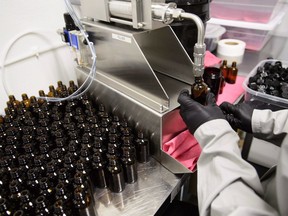 Workers package cannabis oil at Canopy Growth Corporation's Tweed facility in Smiths Falls, Ont., on Monday, Feb. 12, 2018. Toronto researchers have determined what dosage of a specially formulated cannabis oil is safe and can be tolerated by children with Dravet syndrome, a rare genetic form of epilepsy that causes lifelong seizures.THE CANADIAN PRESS/Sean Kilpatrick