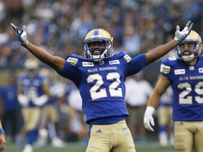 Winnipeg Blue Bombers' Chandler Fenner (22) celebrates after tackling Hamilton Tiger-Cats' Chris Williams (2) for a loss of yards during the first half of CFL action in Winnipeg, Friday, August 10, 2018. THE CANADIAN PRESS/John Woods ORG XMIT: JGW103