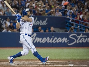 Blue Jays designated hitter Kendrys Morales watches as he hits a three run home run against the Orioles during fifth inning MLB action in Toronto on Monday, Aug. 20, 2018.