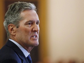 Manitoba Premier Brian Pallister speaks during his cabinet shuffle at the Manitoba Legislature in Winnipeg on August 1, 2018. Manitoba Premier Brian Pallister has been penalized for taxes owing on his vacation home in Costa Rica. Pallister failed to update the evaluation of his property as required by Costa Rica law, which allowed him to escape paying a national tax on luxury homes, he said Friday.
