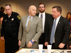 Former Balch Springs police officer Roy Oliver, centre, looks to his defense attorney Miles Brissette, right, before being taken away after being sentenced to 15 years in prison for the murder of 15-year-old Jordan Edwards, Wednesday, Aug. 29, 2018, at the Frank Crowley Courts Building, in Dallas.