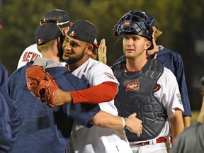 Winnipeg Goldeyes relief pitcher Victor Capellan (wearing glove) celebrates with teammates after their team’s win over Fargo-Moorhead on Aug. 30, 2018. Capellan tied a club record with his 22nd save of the season. (TAYLOR BOEHLIG/Winnipeg Goldeyes)