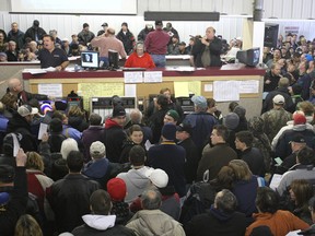 People in a large crowd bid on items at the Winnipeg police auction on Roblin Boulevard just west of Winnipeg.