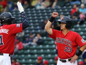 Winnipeg Goldeyes designated hitter Josh Romanski (right) drove in both runs in a 2-1 victory over the Chicago Dogs to avoid a sweep.