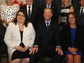 Manitoba Premier Brian Palmister shuffled his cabinet in Winnipeg today.   Pallister is pictured here seated between Colleen Meyer, MLA for St. Vital (left), and Heather Stefanson, MLA for Tuxedo.  Wednesday, August 01/2018 Winnipeg Sun/Chris Procaylo/stf
