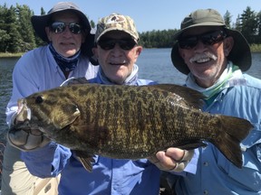 (Left to right) Kim, Roland and Scott Frazier show off their prize catch.