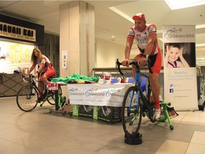 Winnipeg Police Service Patrol Sgt. Shaunna Neufeld and Const. Darrell Hees, members of the Cops for Kids relay team, ride to raise money for The Children's Wish foundation at Cityplace on Friday morning.