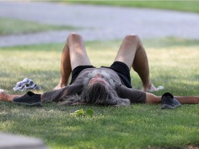 A man with long grey hair and a large beard relaxes in the shade in Memorial Park, in Winnipeg.  The city is currently experiencing a heat wave.    Friday, August 10/2018 Winnipeg Sun/Chris Procaylo/stf