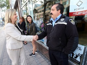 Jenny Motkaluk, mayoral candidate, shakes hands with a Transit employee, Roger, who attended her campaign announcement in Winnipeg on Tuesday.