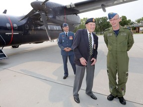 Ninety-eight-year-old Elmer Cole, an honoured Second World War veteran (centre) stands between Colonel Eric Charron, Wing Commander, 17 Wing Winnipeg (left), and Major Darren Michaud, Acting Commanding Officer, 402 Squadron. Cole participated in the Dieppe raid, he was then captured and became a prisoner of war.