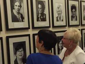 (Left to right) Former MLAs Bonnie Mitchelson and Roseway Vodrey view the Trailblazers Wall on the second floor west hallway at the Manitoba Legislature in Winnipeg on Tuesday.