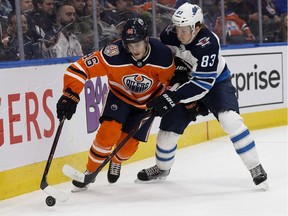 The Edmonton Oilers' Pontus Aberg (46) battles the Winnipeg Jets' Sami Niku (83) during third period pre-season NHL action at Rogers Place, in Edmonton Thursday Sept. 20, 2018. Niku makes his season debut tonight against the Blackhawks. David Bloom/Postmedia Network