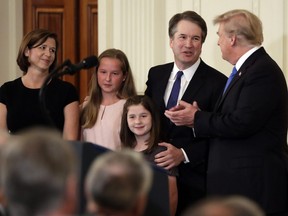 U.S. President Donald Trump greets Judge Brett Kavanaugh his Supreme Court nominee, in the East Room of the White House, Monday, July 9, 2018, in Washington.