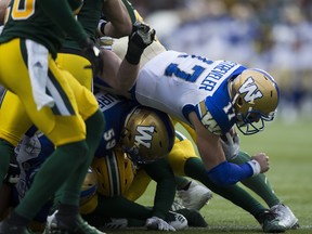 Winnipeg Blue Bombers Chris Streveler dives into the end zone for a touchdown against the Edmonton Eskimos during first half CFL action on Saturday.