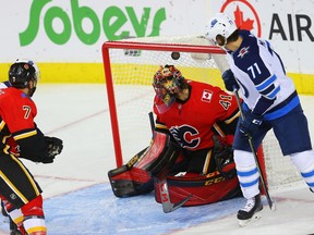 Calgary Flames Mike Smith gives up a goal to C.J. Suess of the Winnipeg Jets during NHL pre-season hockey at the Scotiabank Saddledome in Calgary on Monday, September 24, 2018. Al Charest/Postmedia