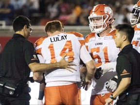 B.C. Lions quarterback Travis Lulay (14) is helped off the field after being injured during first half CFL football action against the Montreal Alouettes in Montreal, Friday, September 14, 2018. Nothing good seems to happen in September when Travis Lulay faces the Montreal Alouettes. The veteran quarterback suffered a dislocated left shoulder on the opening series of the B.C. Lions' 32-14 road win in Montreal on Friday night. THE CANADIAN PRESS/Graham Hughes ORG XMIT: CPT130