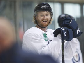 Winnipeg Jets' Kyle Connor (81) smiles during a skating time trial during the Jets NHL training camp.