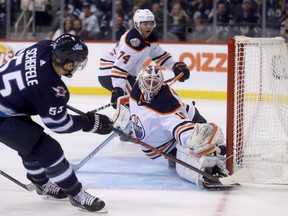 Jets’ Mark Scheifele scores on Oilers’ goaltender Mikko Koskinen during second period last night.  Trevor Hagan/CP