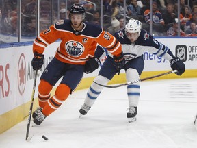 Winnipeg Jets’ Jacob Trouba chases Edmonton Oilers’ Connor McDavid during pre-season action in Edmonton last month.