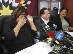 Martina Saunders, former vice-president of Keeyask Hydro Power Limited Partnership, wipes a tear as she speaks about her experience and about the social impacts of hydro development across Manitoba Keewatinowi Okimakanak (MKO) territory as, from left, MKO Grand Chief Garrison Settee, and Hilda Anderson-Pyrz, Missing and Murdered Indigenous Women and Girls Liaison for MKO listen in during a press conference in Winnipeg, Tuesday, Sept. 4, 2018. THE CANADIAN PRESS/John Woods