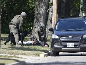 The RCMP emergency response unit arrests an alleged suspect in Neepawa, Man., on Thursday, August 30, 2018, following the shooting of a RCMP officer in Onanole, Man.