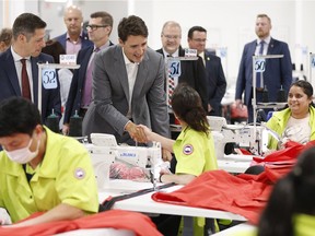 Prime Minister Justin Trudeau meets employees during a brief tour of a new 700 employee Canada Goose manufacturing facility in Winnipeg on Tuesday.