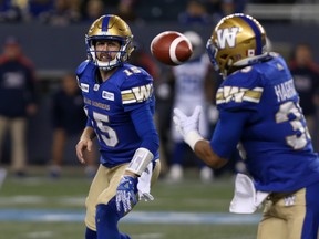 Winnipeg Blue Bombers QB Matt Nichols (left) pitches the ball to RB Andrew Harris last night. (Kevin King/Winnipeg Sun)