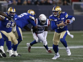 Blue Bombers quarterback Matt Nichols (right) scrambles against the Alouettes in Winnipeg last night. (KEVIN KING/WINNIPEG SUN)