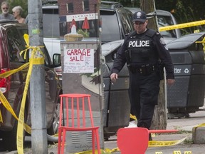 Patio chairs and evidence markers on Danforth Ave. at Logan following a mass shooting, on Monday July 23, 2018.