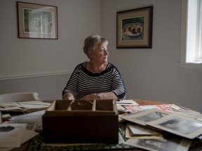 Nancy McIntosh poses for a photo while looking at historic artifacts from her families apple business in the Morrisburg, Ont. Her ancestor, John McIntosh, discovered the original McIntosh Apple on a farm in the nearby town of Dundela, Ont, in 1811.