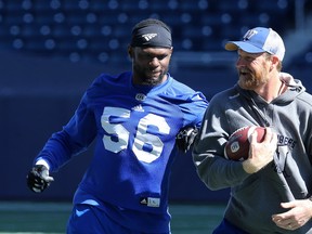 Gerald Rivers (left) playfully tries to slap the ball away from head coach Mike O'Shea during Winnipeg Blue Bombers practice on Wed,. Sept. 5, 2018. Kevin King/Winnipeg Sun/Postmedia Network