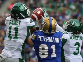 Saskatchewan Roughriders DB Ed Gainey (left) intercepts a pass intended for Winnipeg Blue Bombers SB Daniel Peterman during CFL action in Winnipeg on Sat., Sept. 8, 2018. Kevin King/Winnipeg Sun/Postmedia Network