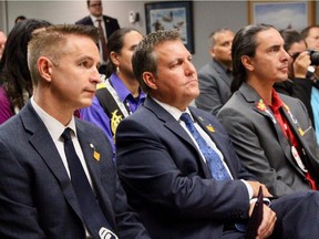 (left to right) Moose Hide Campaign co-founder Paul Lacerte, Justice Minister Cliff Cullen and Assembly of Manitoba Chiefs Grand Chief Arlen Dumas listen to RCMP Assistant Commissioner Scott Kolody (not pictured) speak at an event at RCMP headquarters in Winnipeg on Monday.