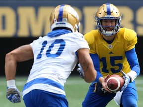 Quarterback Matt Nichols (right) pitches to slotback Nic Demski during Winnipeg Blue Bombers practice on Monday.