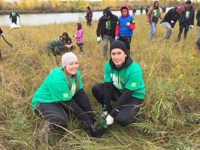 (Left to right) TD Tree Days site leaders Mellaina Kereluik and Alen Planincic help plant a white spruce at the Fort Whyte Alive in Winnipeg as part of the ninth annual TD Tree Days on Sunday. Roughly 100 volunteers planted 450 trees as part of a larger target to plant one million trees by 2030.