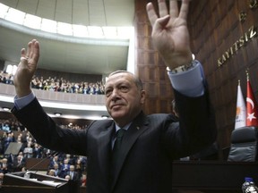 Turkey's President Recep Tayyip Erdogan waves as he arrives to deliver a speech in Ankara, Turkey, Tuesday, Dec. 5, 2017. (Yasin Bulbul/Pool via AP)