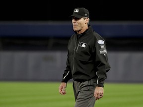 First base umpire Angel Hernandez (5) watches from his position Game 3 of the American League Division Series Monday, Oct. 8, 2018, in New York.