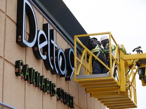 Sign installers work on the finishing touches to the new Delta 9 Cannabis Store signage in Winnipeg. Cannabis becomes legal in Canada on Oct. 17.