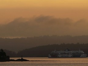 In this Sept. 25, 2018 photo, a BC Ferries boat sails near Vancouver Island, British Columbia, at sunrise.