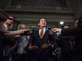 Leader of the Opposition in the Manitoba Legislative Assembly, Wab Kinew scrums at the Manitoba Legislature in Winnipeg on March 12, 2018. The leader of the Manitoba's Opposition is calling for an inquest into the death of an Indigenous man who died on a bus travelling to Winnipeg for a medical appointment. Abraham Donkey, who was 58, was travelling from Thompson for a follow-up appointment after a recent heart surgery. He died on October 3rd during a 10-hour bus trip. NDP Leader Wab Kinew says both Manitoba Health and the federal government's First Nations and Inuit Health Branch didn't offer to pay for a flight and refused to cover expenses for a family member to go with Donkey.