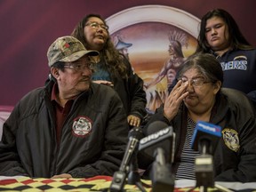 Rex and Hager Ross, bottom right, parents of Mary "Tom" Yellowback are seen with Mary's aunt Louise Ross Okemow, rear left, and Mary's daughter Pearl Yellowback, rear right, during a press conference at the Manitoba Keewatinowi Okimakanak office in Winnipeg on Tuesday.