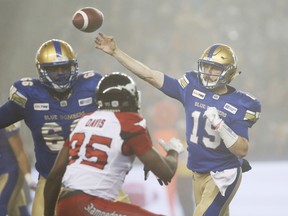 Winnipeg Blue Bombers quarterback Matt Nichols (15) throws in the fog against the Calgary Stampeders during the second half of CFL action in Winnipeg, last Friday.