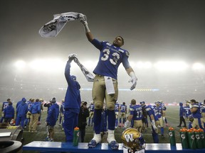 Winnipeg Blue Bombers' Andrew Harris (33) cheers with the crowd in the last seconds of their CFL game against the Calgary Stampeders, in Winnipeg, Friday, Oct. 26, 2018.