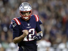 New England Patriots quarterback Tom Brady pumps his fist after throwing a touchdown pass to Cordarrelle Patterson during the first half of an NFL football game against the Indianapolis Colts, Thursday, Oct. 4, 2018, in Foxborough, Mass.