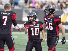 Ottawa Redblacks kicker Lewis Ward celebrates with Ottawa Redblacks quarterback Trevor Harris during second half CFL football game action against the Hamilton Tiger-Cats in Hamilton, Ont., on Saturday, July 28, 2018. After sitting out the last five games Jon Gott will finally be back in the Ottawa Redblacks lineup Friday night. While Gott can't help thinking about the end of his career, rookie kicker Lewis Ward is having a breakout season and is two kicks away from tying Rene Paredes record of 39 consecutive field goals. THE CANADIAN PRESS/Peter Power ORG XMIT: CPT119