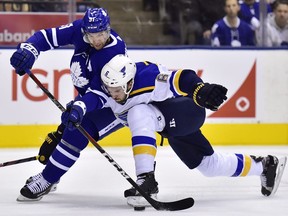 St. Louis Blues defenceman Joel Edmundson (6) attempts to take the puck from Toronto Maple Leafs centre John Tavares (91) during first period NHL action in Toronto on Saturday, Oct. 20, 2018.