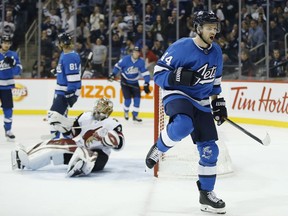 Winnipeg Jets' Josh Morrissey (44) celebrates as his shot beats Arizona Coyotes goaltender Antti Raanta (32) during second period NHL action in Winnipeg on Saturday.