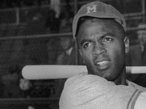American baseball player Jackie Robinson holding a bat in his Montreal Royals uniform, the Brooklyn Dodgers farm team, circa 1946. (Keystone/Archive Photos/Getty Images)